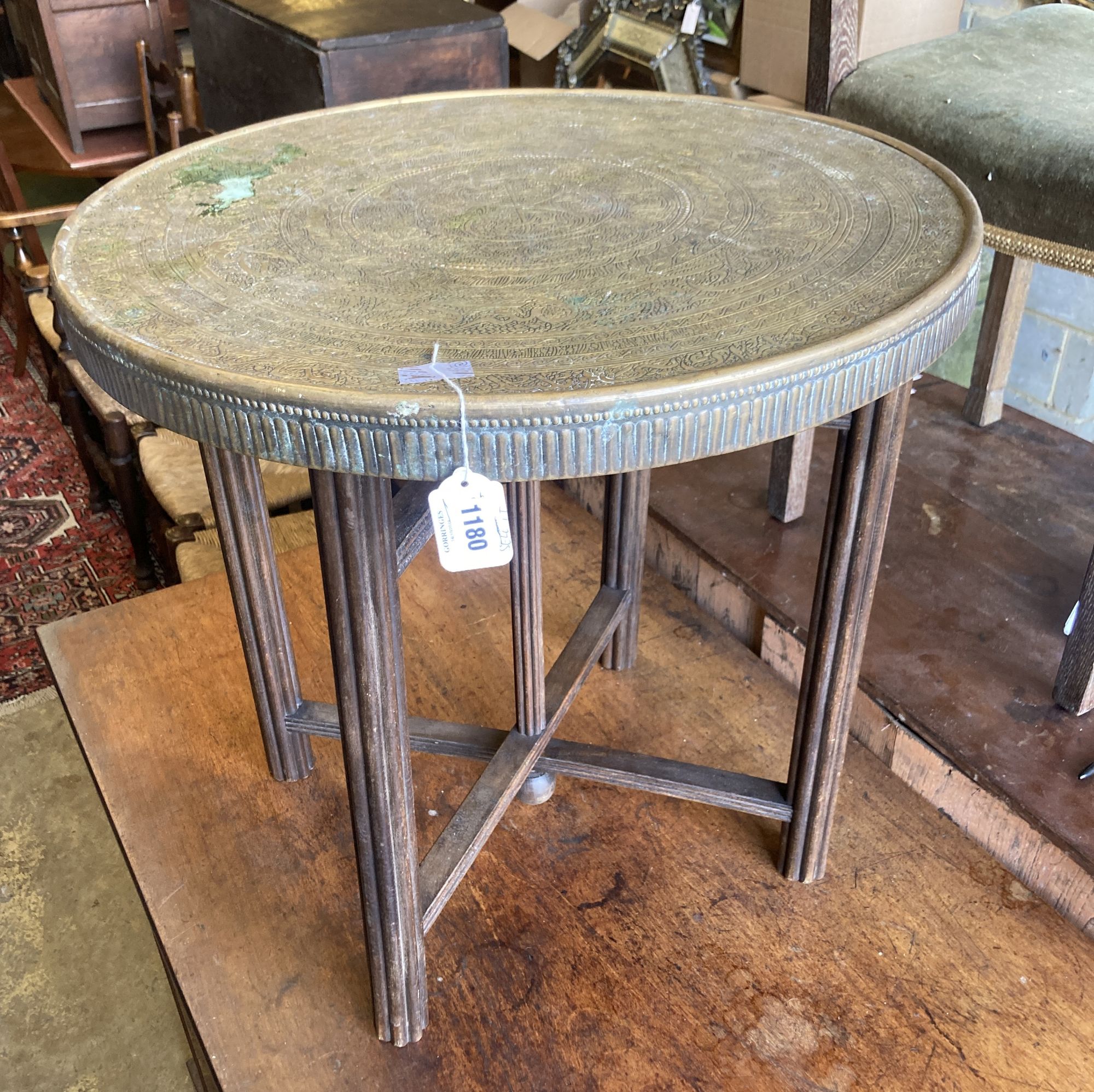 A Benares circular brass tray top occasional table, diameter 59cm, height 58cm Diam.60cm